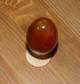 Сердолик в виде яйца на деревянной подставке